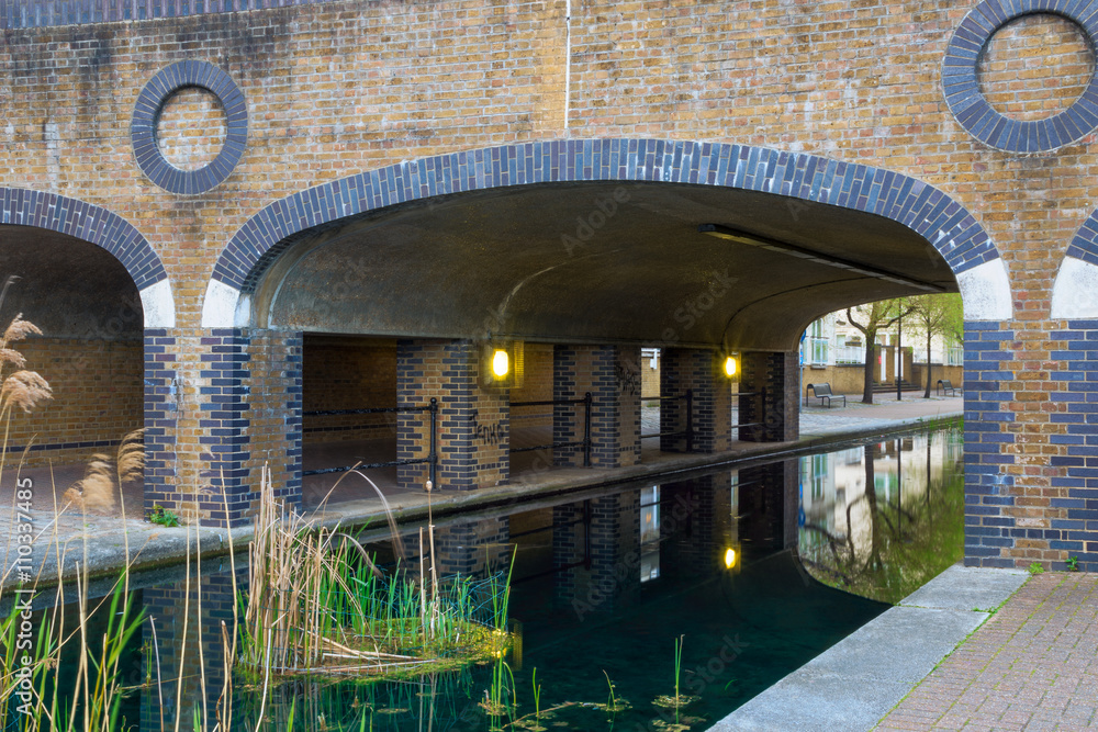 Albion Channel under a path bridge, an ornamental canal created linking Canada Water to Surrey Water Albion Channel under a path bridge, an ornamental canal created linking Canada Water to Surrey Water