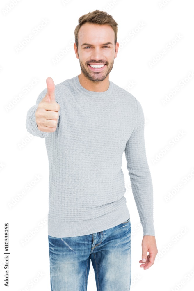 Young man smiling and giving a thumbs up Young man smiling and giving a thumbs up