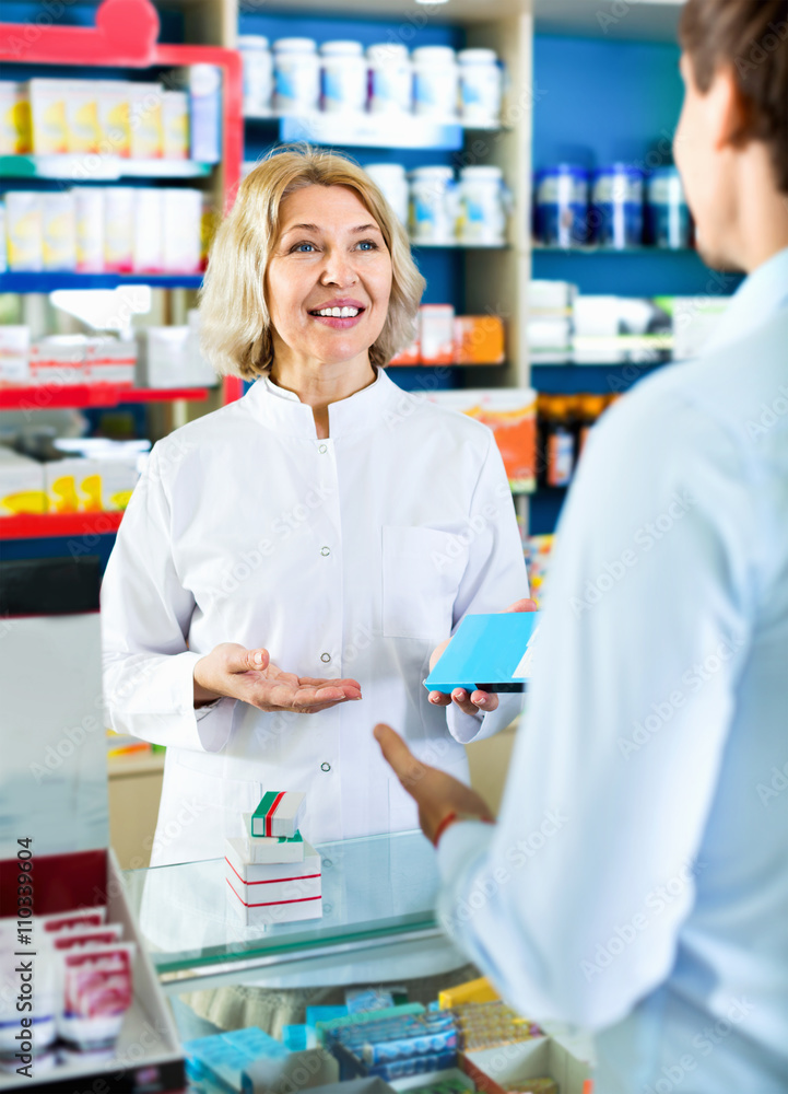 Female pharmacist counseling customer about drugs usage