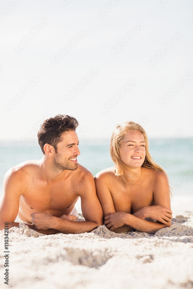 Young couple lying on sand Young couple lying on sand
