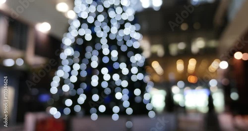 Christmas tree near office building, pan up