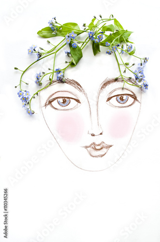 Fototapeta Naklejka Na Ścianę i Meble -  Beautiful woman face with green plant and blue flowers instead of hair, isolated on white background. Floral spring girl
