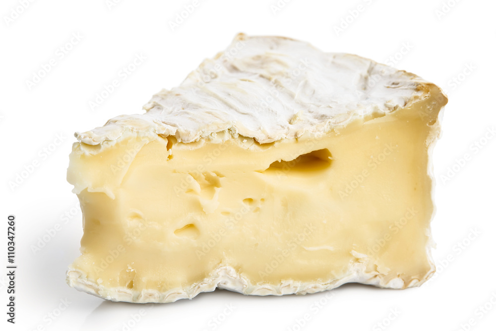 Detail of one piece of white mould cheese isolated on white.