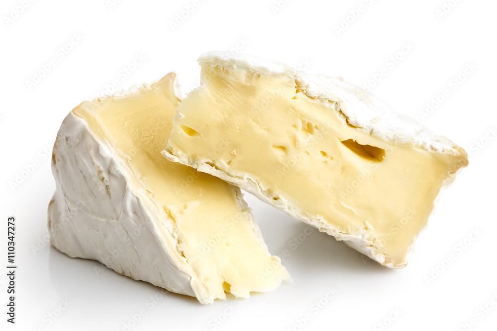 Two pieces of white mould cheese isolated on white.