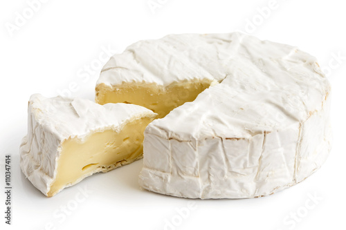 White mould cheese with cut slice isolated on white. photo