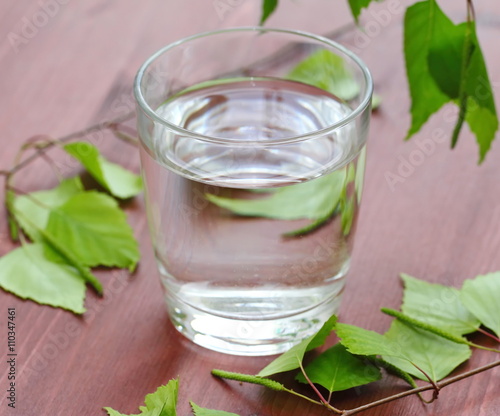 Glass of clean water on natural background