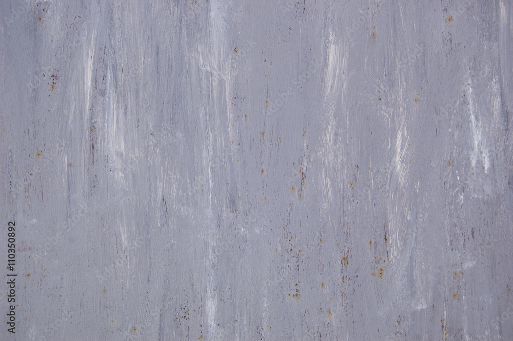 Abstract grey metal background with rust and white paint traces.