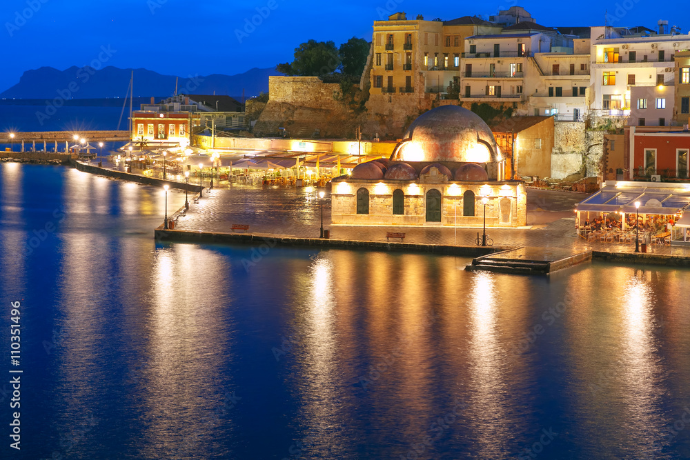 Picturesque panoramic view of Venetian quay of Chania with Kucuk Hasan Pasha Mosque during twilight blue hour, Crete, Greece