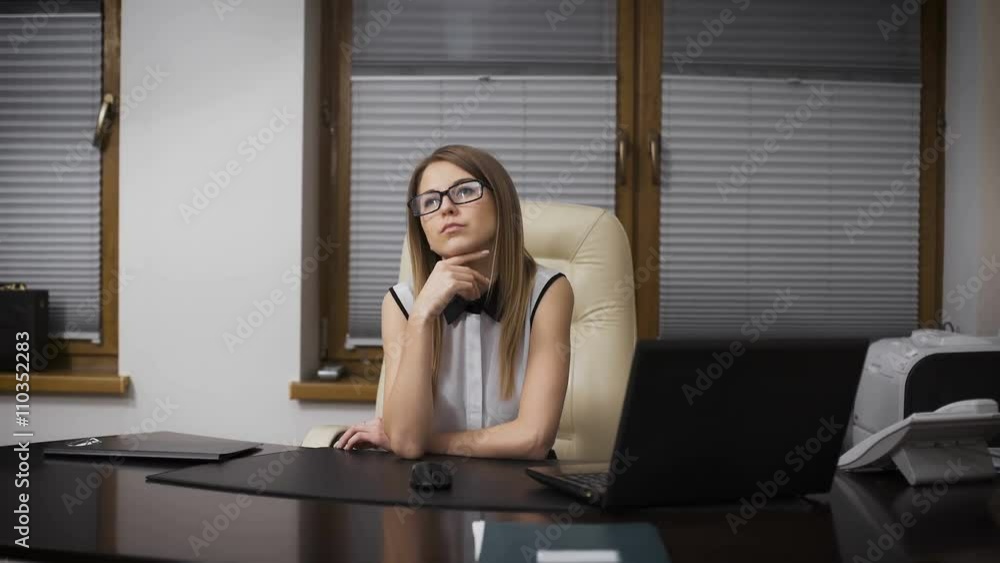 Secretary Girl distracted from work. She sits at a desk and dreaming of vacation. Secretary Girl distracted from work. She sits at a desk and dreaming of vacation.