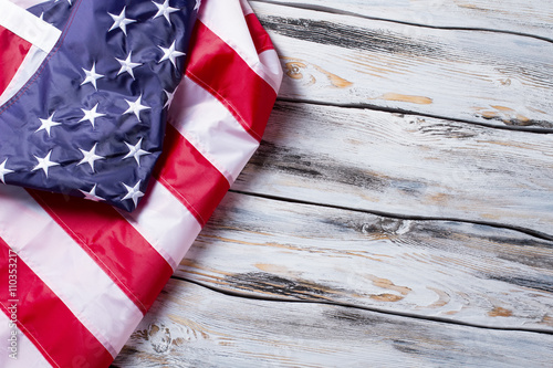 Fototapeta Naklejka Na Ścianę i Meble -  Crumpled flag of America. American flag on wooden background. Preserve the rights and freedoms. Land of great opportunities.