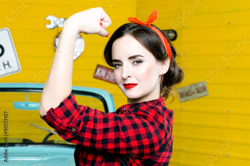  Young Woman With Pinup Hair Style And Makeup Posing In Retro Studio