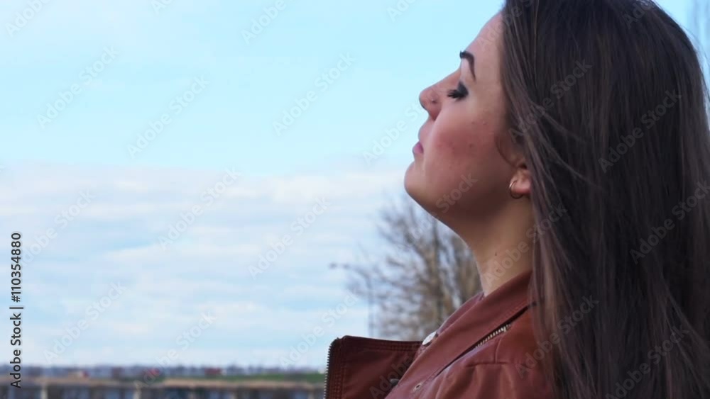 A bird flies past a pensive girl A bird flies past a pensive girl