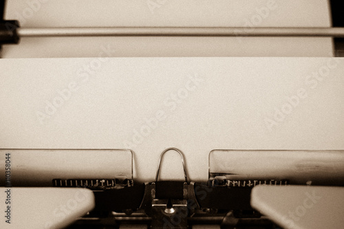 Sepia version of a detail view of a sheet of parchment paper in a typewriter, circa 1970.  Paper may be used as copy space.  May be used to add a message, such as Dear Dad for Father's Day.