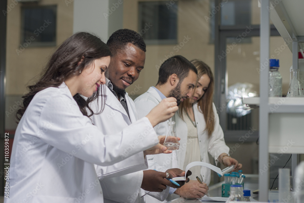 Group of young medical workers are working in lab as lab technicians Group of young medical workers are working in lab as lab technicians