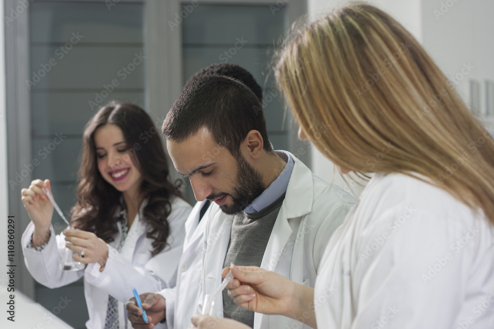 Group of young medical workers are working in lab as lab technic Group of young medical workers are working in lab as lab technic
