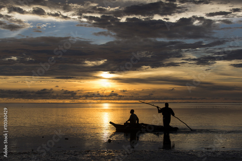 Fishermen going on ocean on traditional fishing boat in Zanzibar