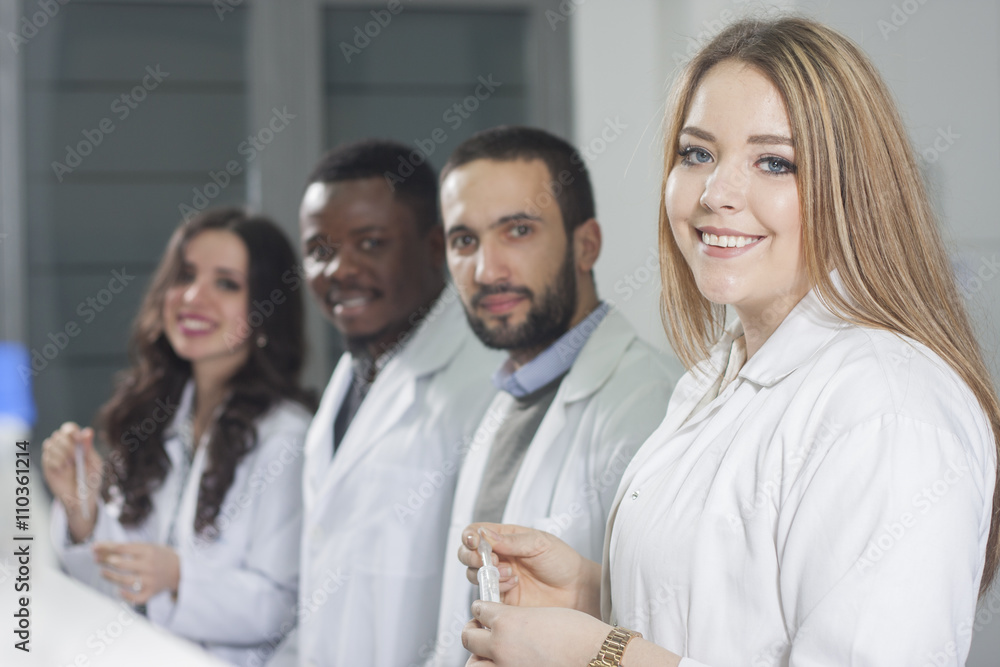 Group of young medical workers are working in lab as lab technic Group of young medical workers are working in lab as lab technic