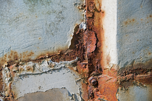detail of a weathered wall with a rusty frame and ragged plaster