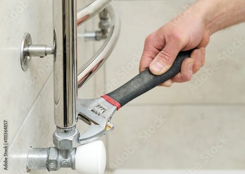 Plumber sets valve for towel warmer.
