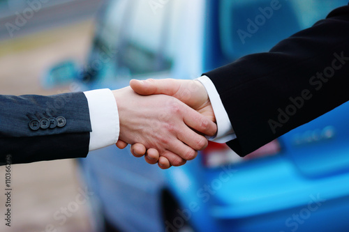 Handshake in auto show or salon