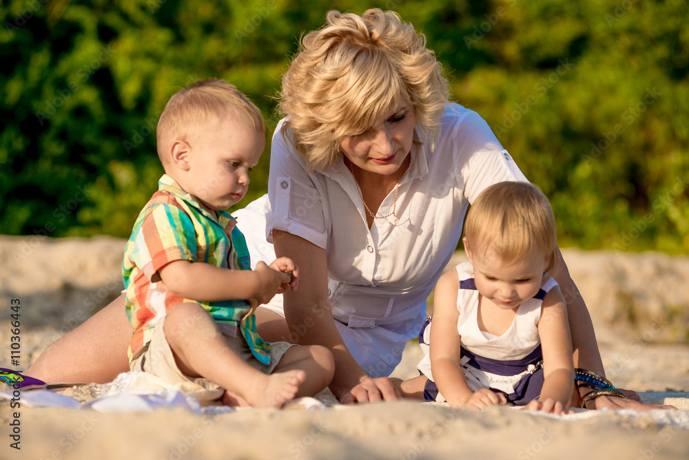 mother with two children on beach mother with two children on beach