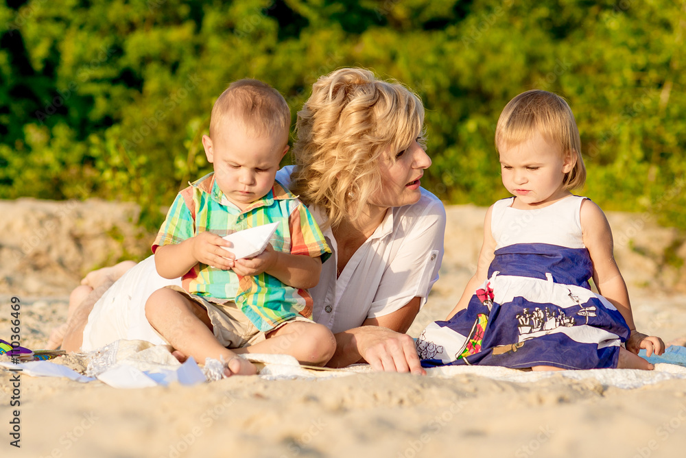 mother with two children on beach mother with two children on beach