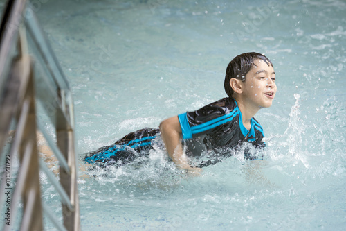 Asian boy swimming on the weekend.