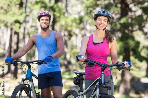 Cheerful young couple with mountain bikes