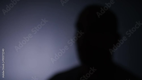 4K Blurred silhouette of anonymous person talking to keep identity concealed, space for text
