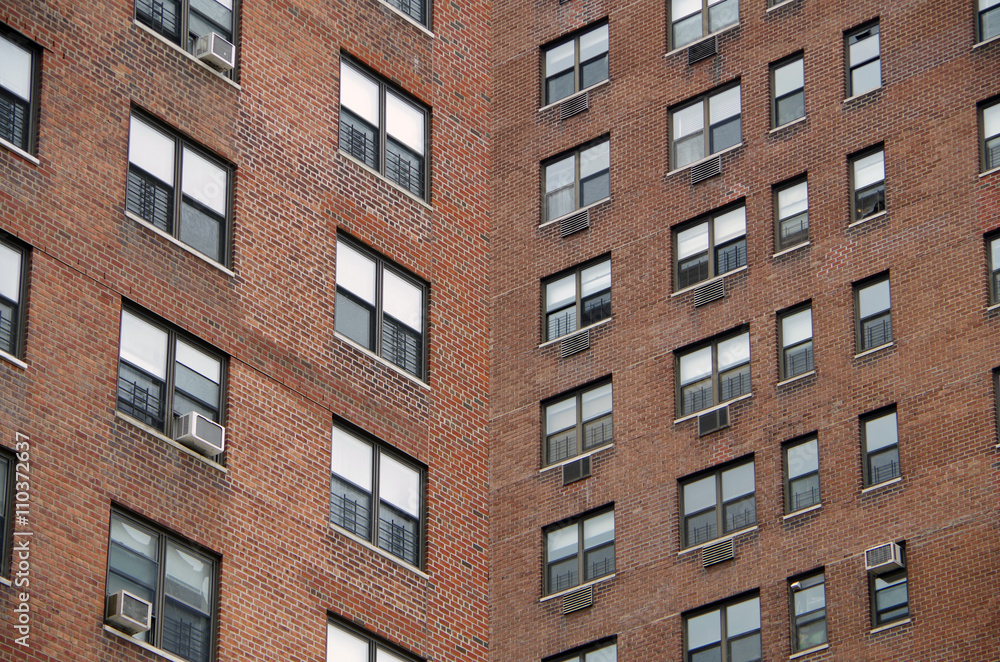 Looking up at a  detail view of a  nyc apartment buildings intersecting perspective