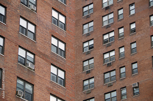 Looking up at a  detail view of a  nyc apartment buildings intersecting perspective