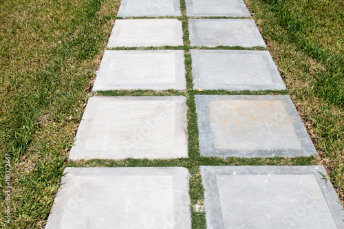 Path made from square pavers in grass