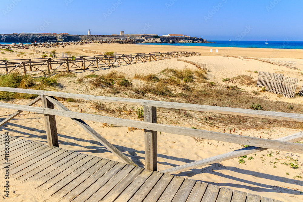 Boardwalk and fence on sandy beach, Tarifa, Spain