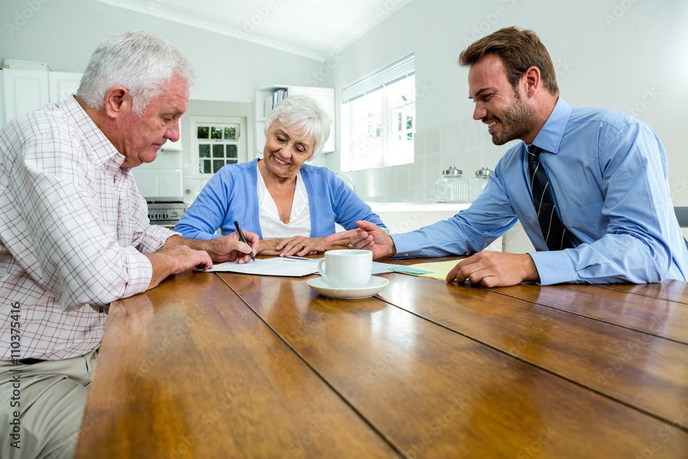 Senior couple discussing with agent Senior couple discussing with agent