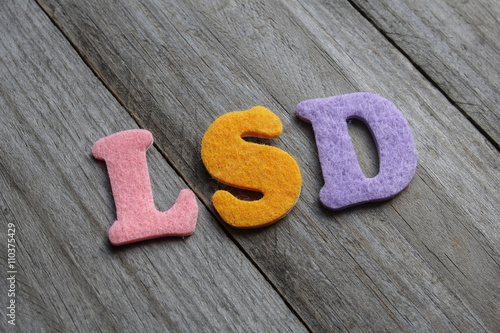 LSD (Lysergic Acid Diethylamide) acronym on wooden background photo