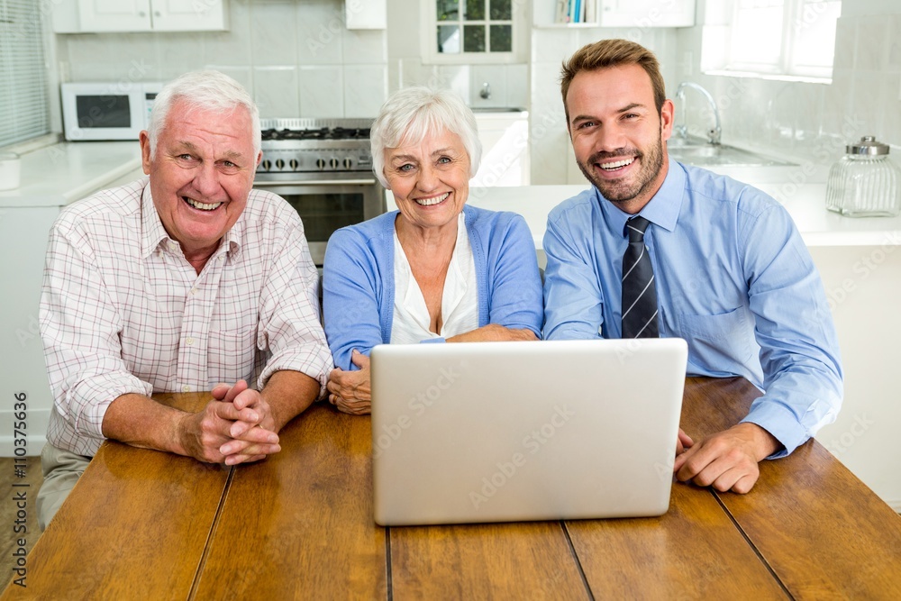 Portrait smiling senior couple sitting with agent Portrait smiling senior couple sitting with agent