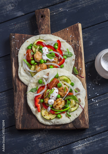 Chicken meatballs and fresh vegetables tacos. Healthy delicious breakfast or snack. On wooden rustic board