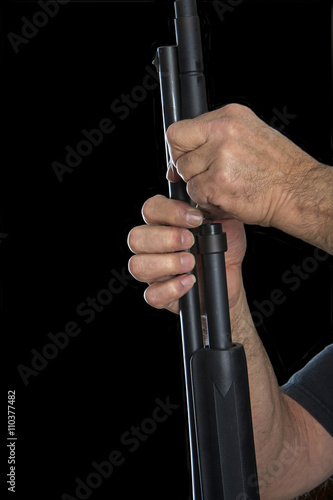 Gunsmith removing barrel of a 20 gauge pump action shotgun for cleaning
