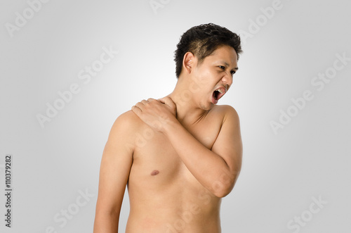 The man has back pain isolated on gray background