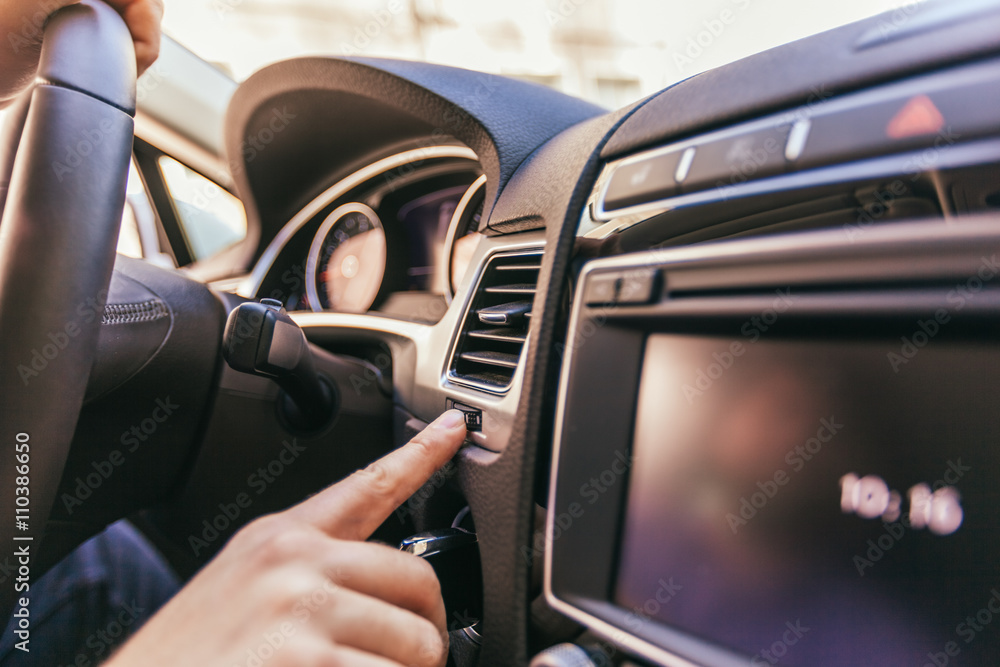 Close-up of a male hand  in a modern car