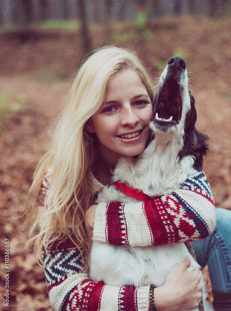 Portrait of beautiful young woman playing with dog outdoor. Portrait of beautiful young woman playing with dog outdoor.