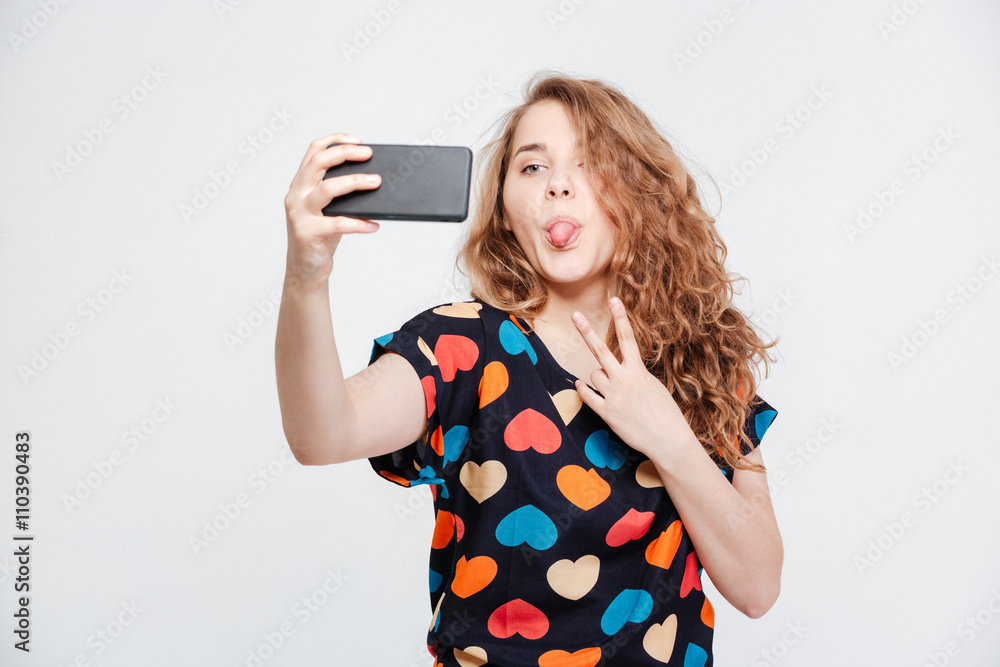 Funny woman making selfie photo on smartpone Funny woman making selfie photo on smartpone