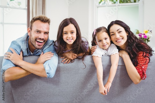 Happy family relaxing on sofa at home 
