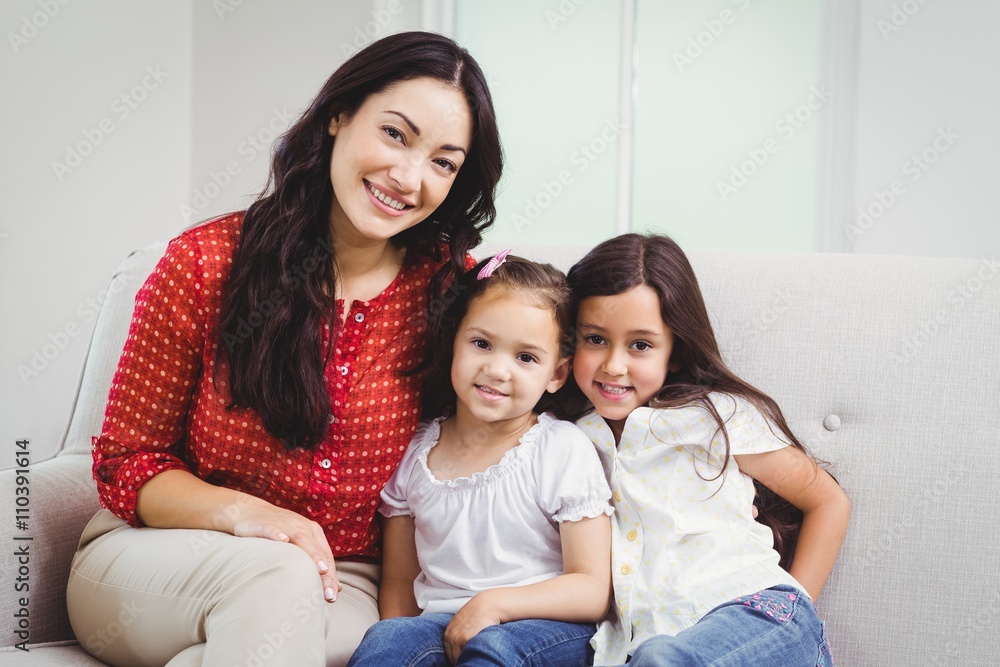 Portrait of smiling mother and daughters at home Portrait of smiling mother and daughters at home