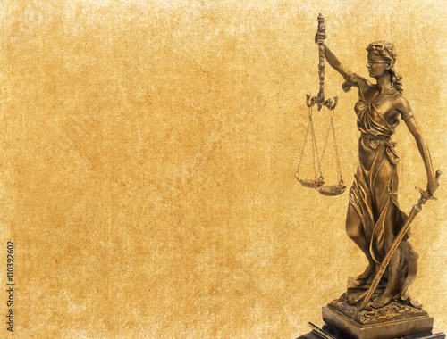 Statue of justice on old paper background, law concept