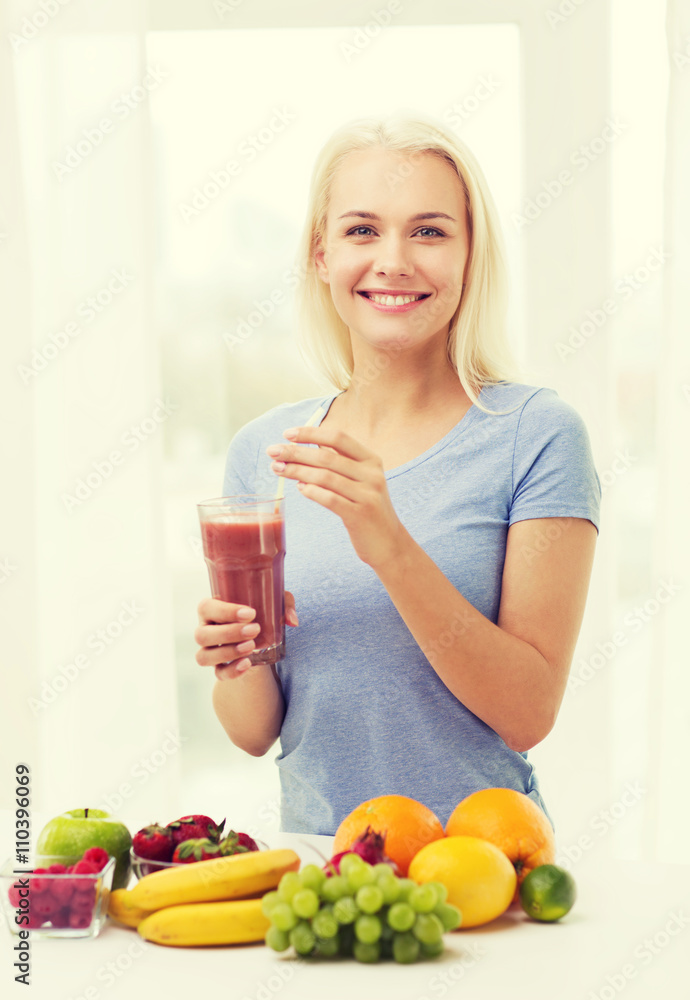 smiling woman drinking fruit shake at home smiling woman drinking fruit shake at home