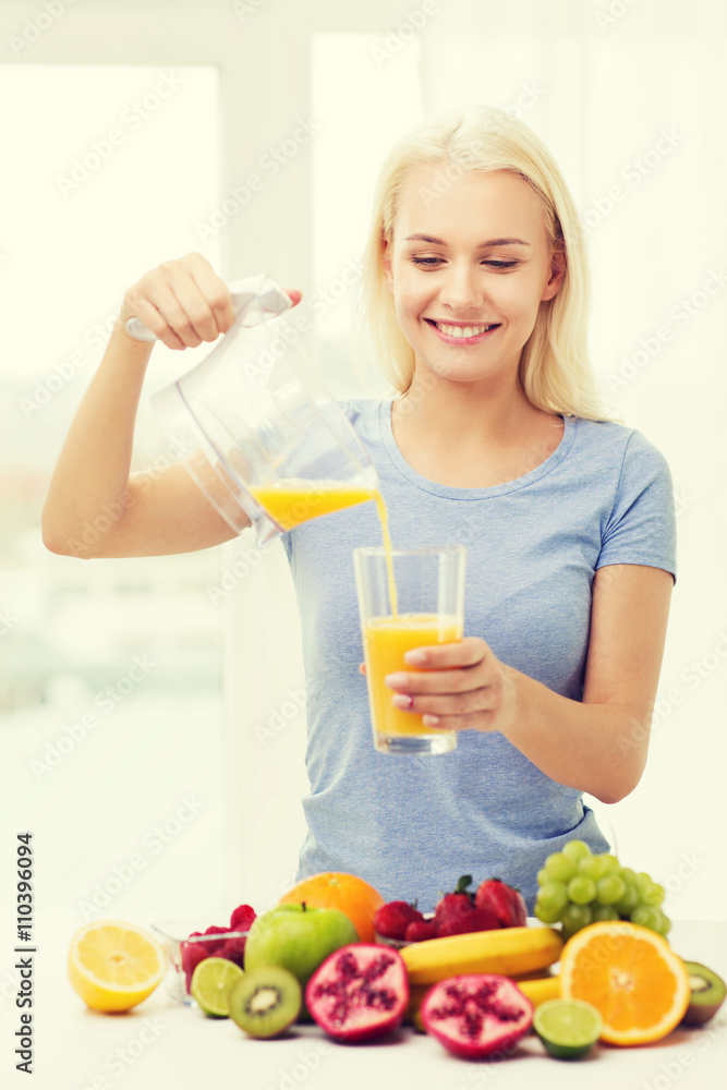 smiling woman pouring fruit juice to glass at home smiling woman pouring fruit juice to glass at home