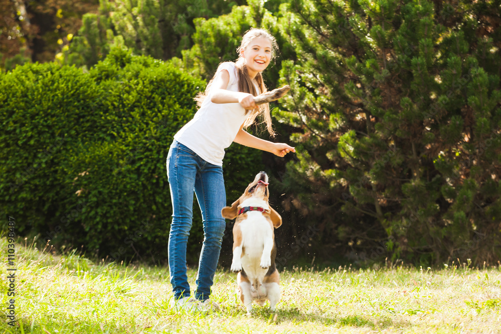 Girl plays with a dog in the yard Girl plays with a dog in the yard