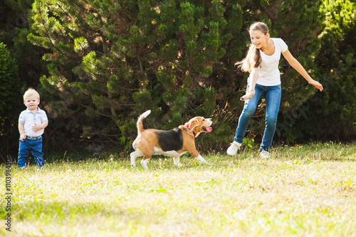 Girl plays with a dog in the yard