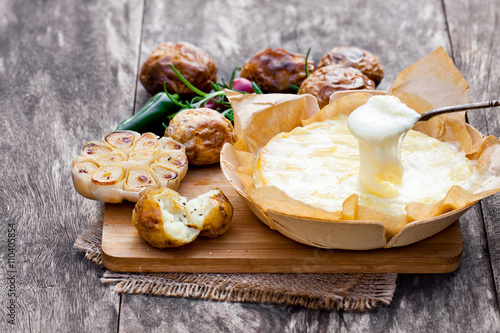 Delicious  baked camembert with roasted potato and garlic